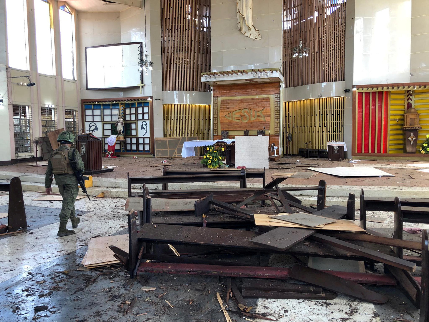 A Philippine army member inspects damage inside the Cathedral of Our Lady of Mount Carmel following a bomb blast in Jolo Jan. 27, 2019. The explosion, just before morning Mass, killed at least 20 people and wounded dozens of others.